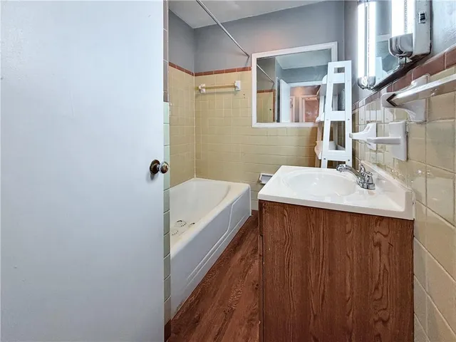 a bathroom with a sink a mirror and a bathtub