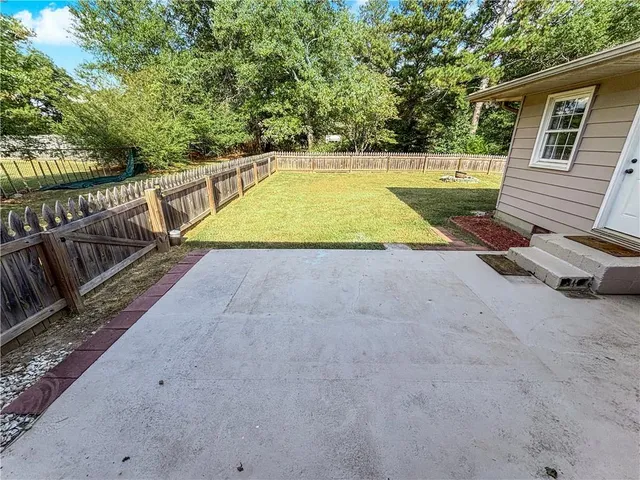 a view of a backyard with swimming pool