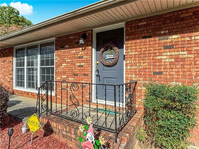 a view of a porch with a table and chairs