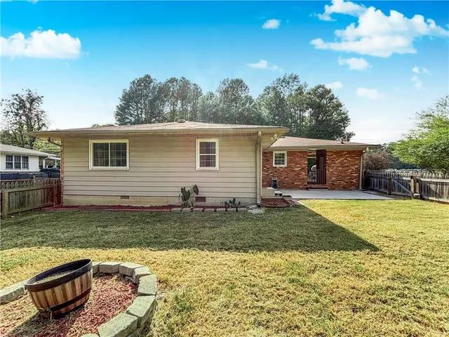 a backyard of a house with barbeque oven