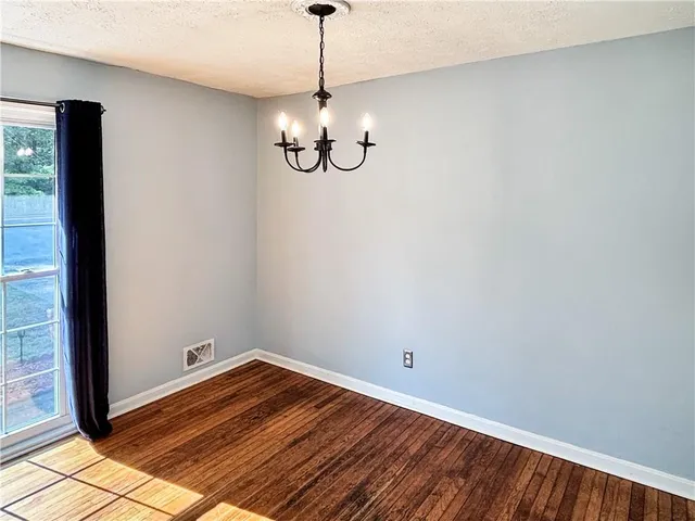 a view of a room with wooden floor and windows