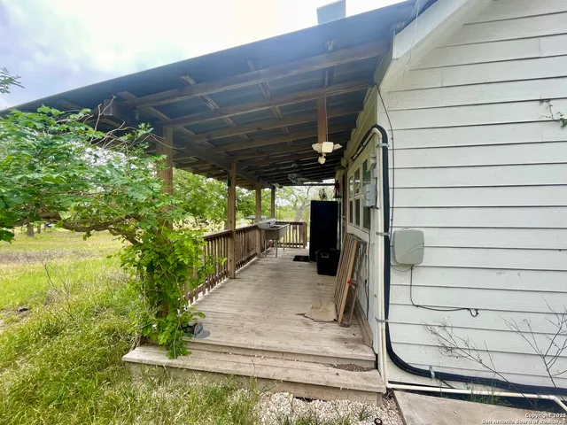 a view of a house with a yard balcony and tree