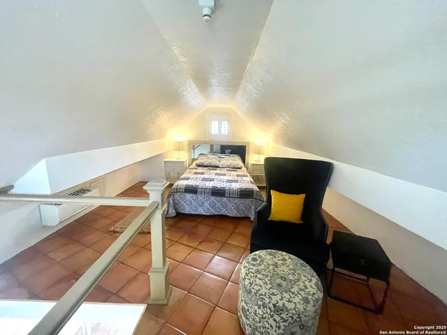 a bedroom with furniture and a window