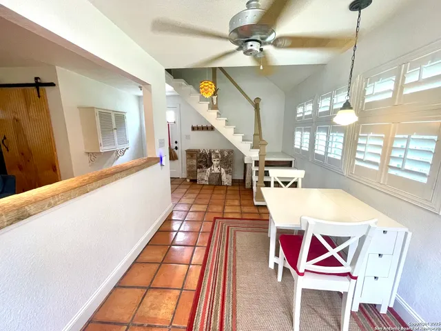 a room with stainless steel appliances kitchen island granite countertop wooden cabinets and white stove top oven