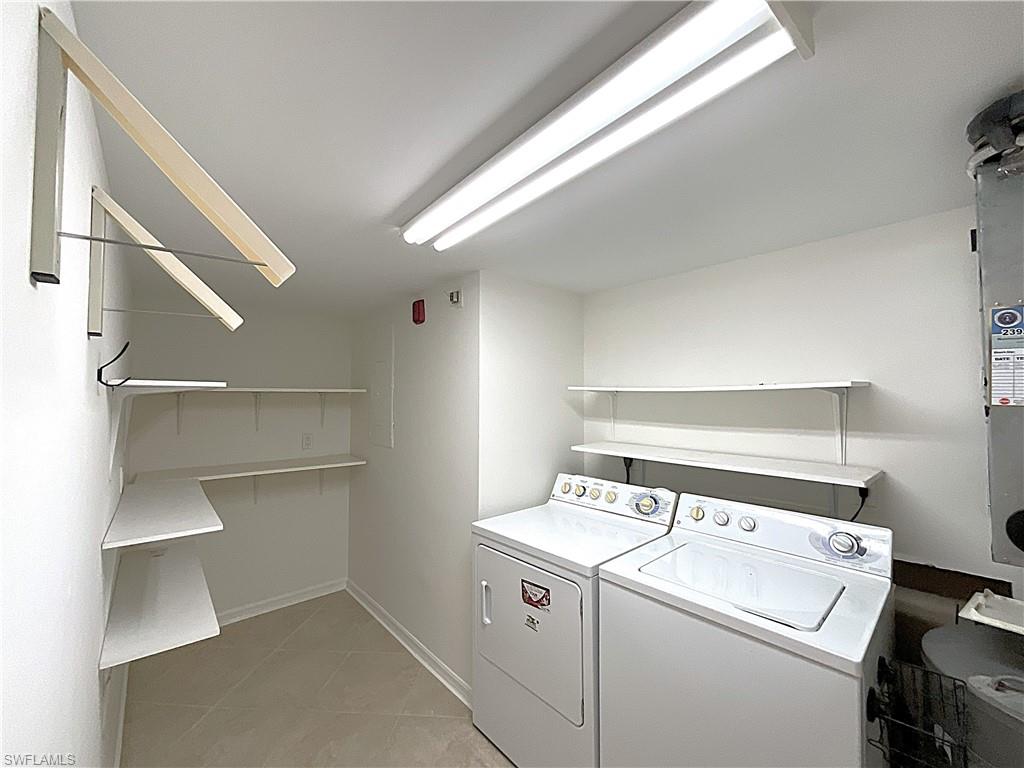 3002 Sandpiper Bay Circle, Unit A103 Naples, FL 34112 - Photo 14 of 25 a utility room with dryer and washer