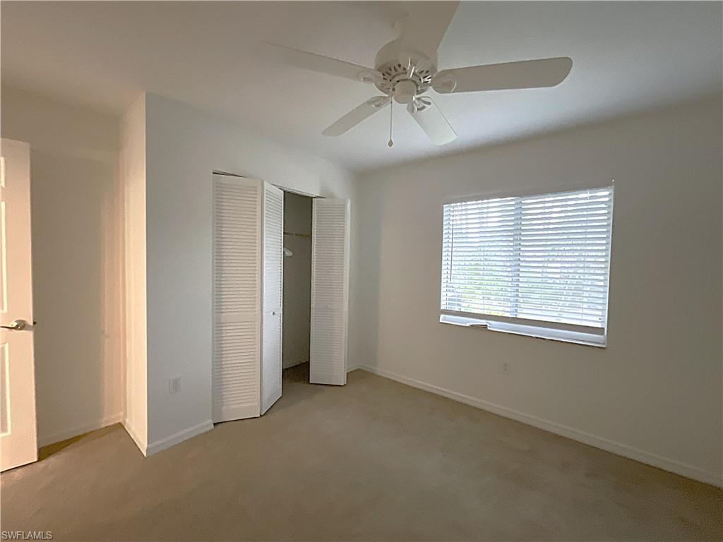 3002 Sandpiper Bay Circle, Unit A103 Naples, FL 34112 - Photo 16 of 25 a view of an empty room with a window