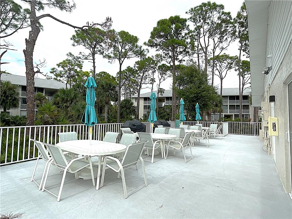 3002 Sandpiper Bay Circle, Unit A103 Naples, FL 34112 - Photo 24 of 25 a view of a dinning table and chairs in the patio