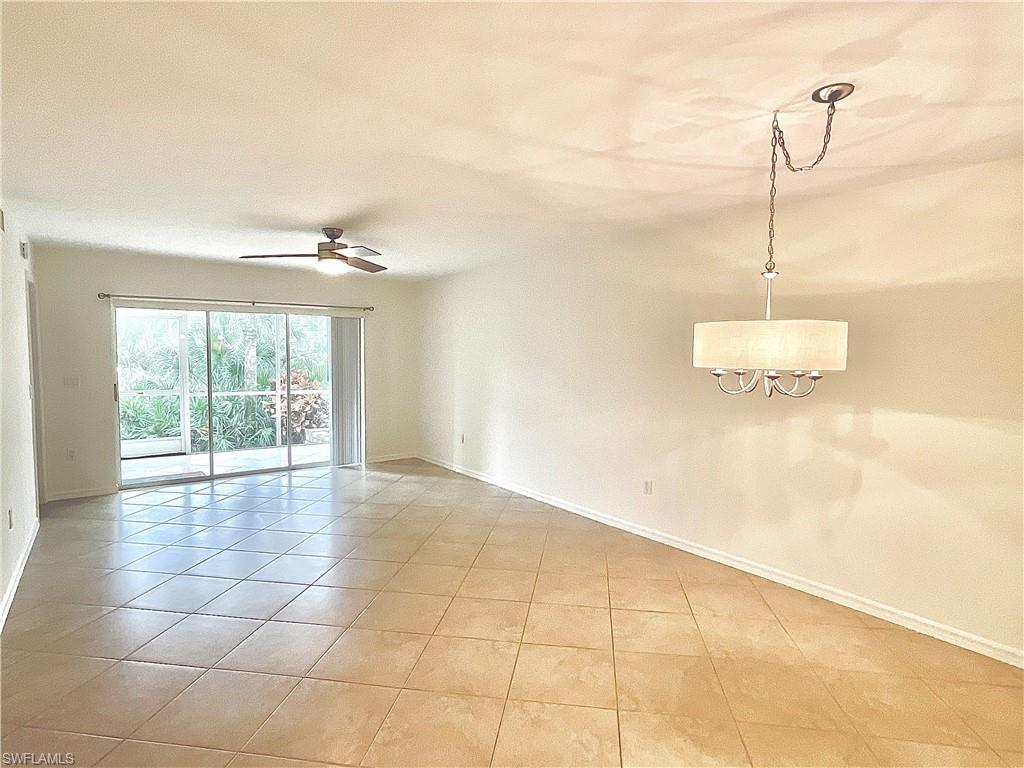 3002 Sandpiper Bay Circle, Unit A103 Naples, FL 34112 - Photo 5 of 25 a view of a room with a ceiling fan and window
