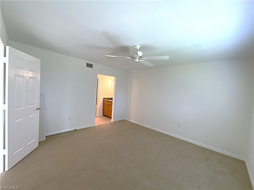 3002 Sandpiper Bay Circle, Unit A103 Naples, FL 34112 - Photo 9 of 25 an empty room with a bathroom