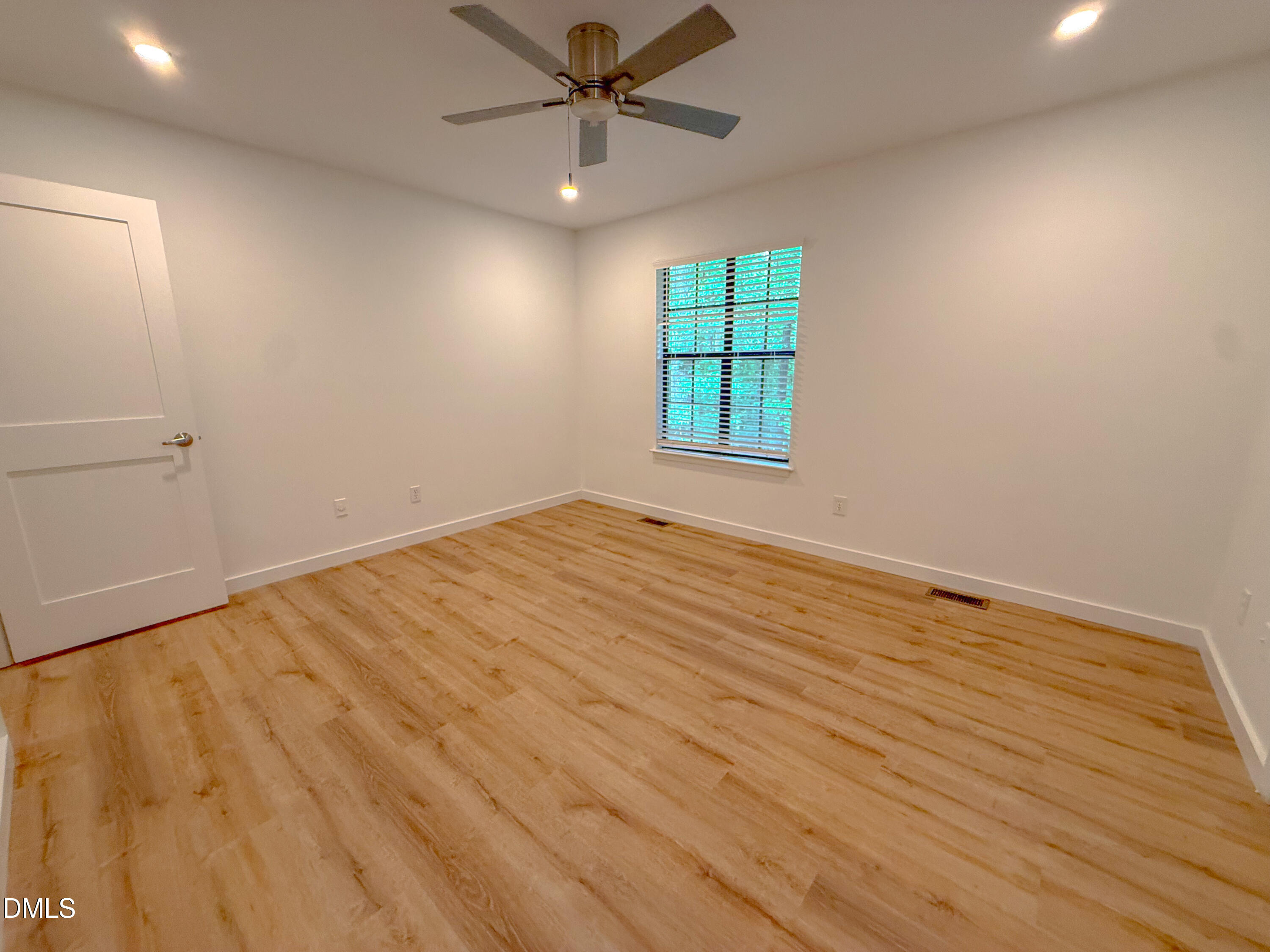 4247 The Oaks Drive Raleigh, NC 27606 - Photo 15 of 21 wooden floor in an empty room with a window
