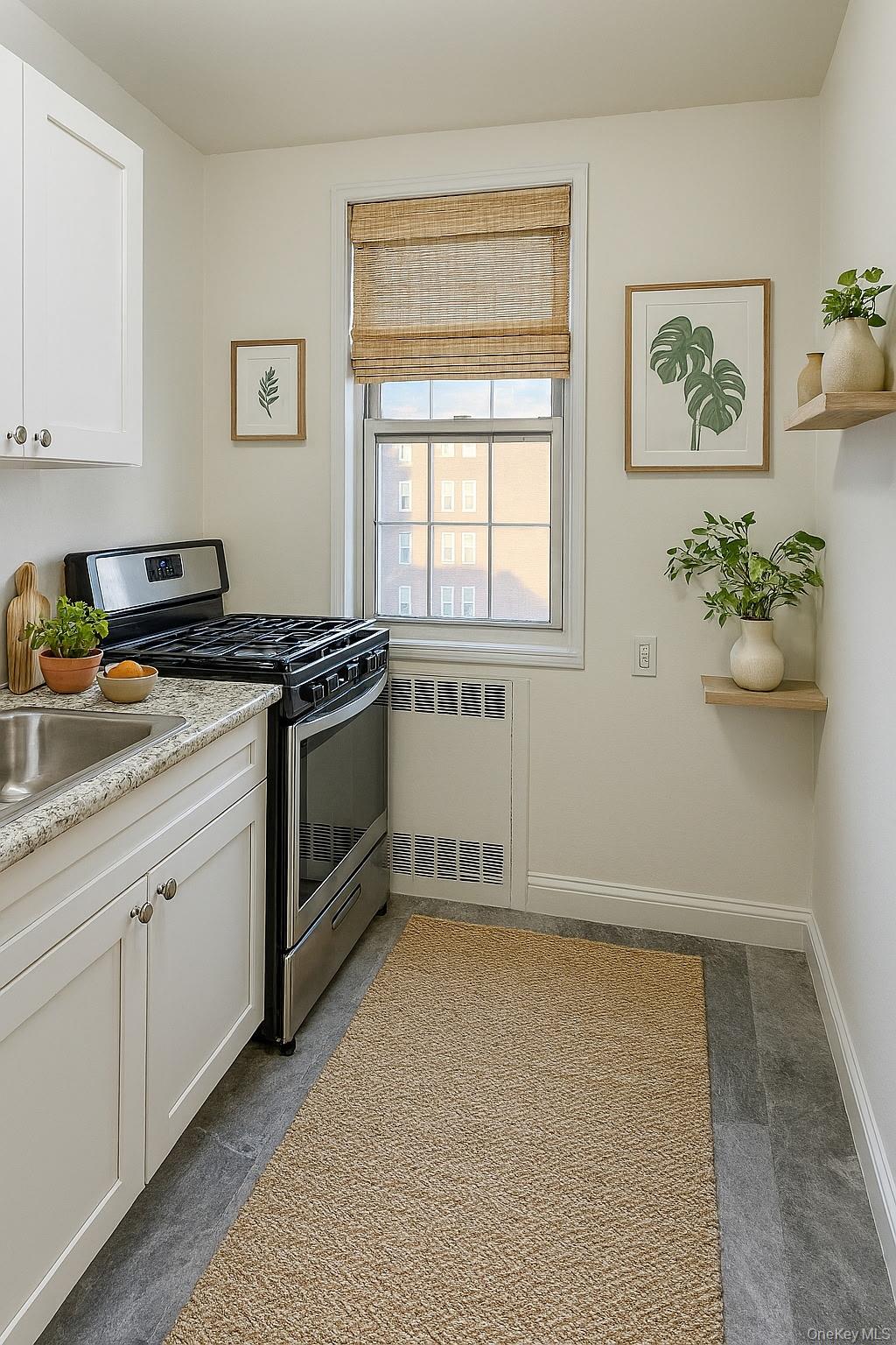 760 Bronx River Road, Unit A65 Bronxville, NY 10708 - Photo 2 of 7 Kitchen with gas stove, white cabinets, and radiator.Virtually staged