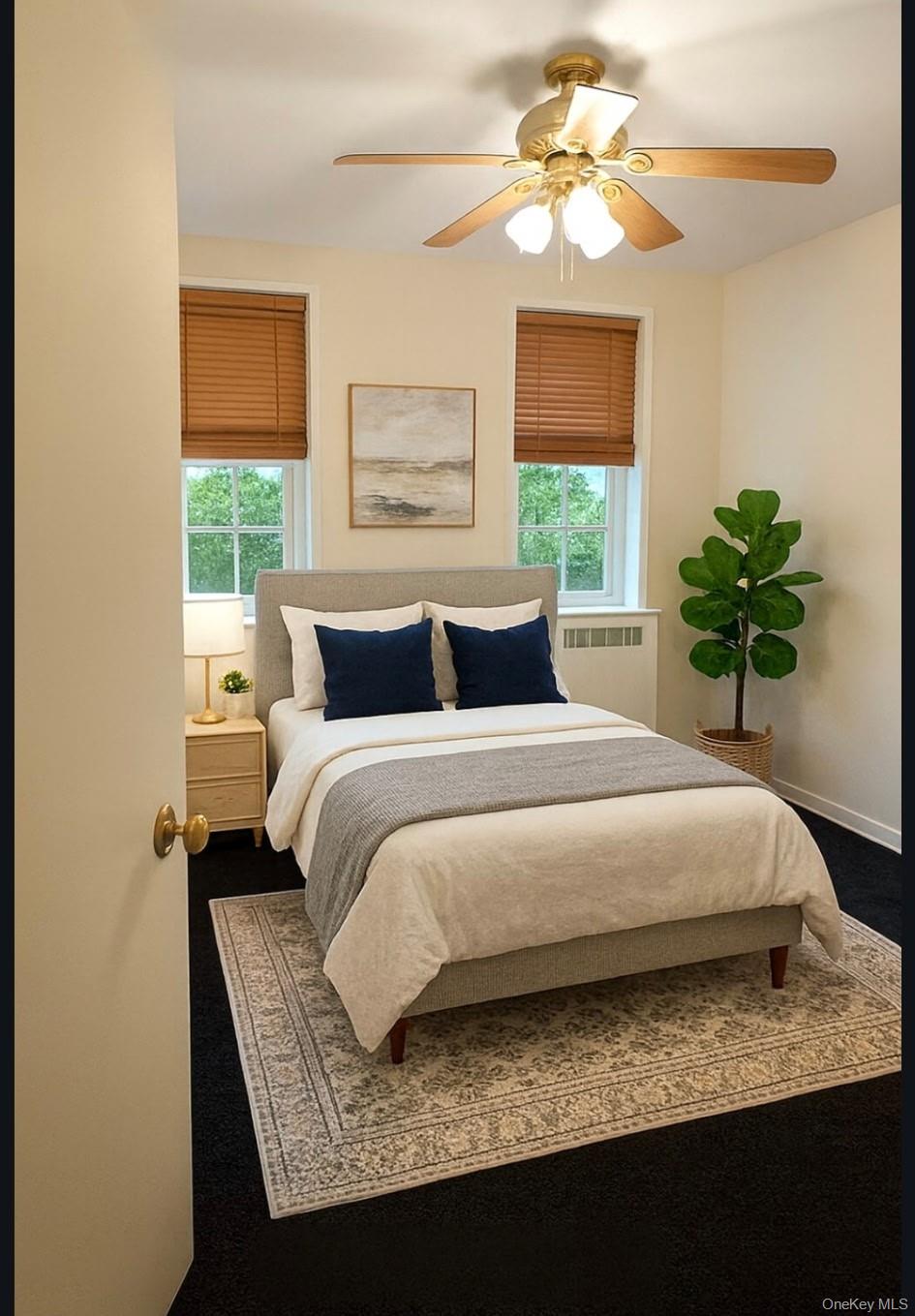 760 Bronx River Road, Unit A65 Bronxville, NY 10708 - Photo 6 of 7 Main Bedroom featuring radiator heating unit and ceiling fan.Virtually staged