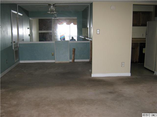 1604 Sharon Road West, Unit 29 Charlotte, NC 28210 - Photo 2 of 5 a view of wooden floor and a kitchen