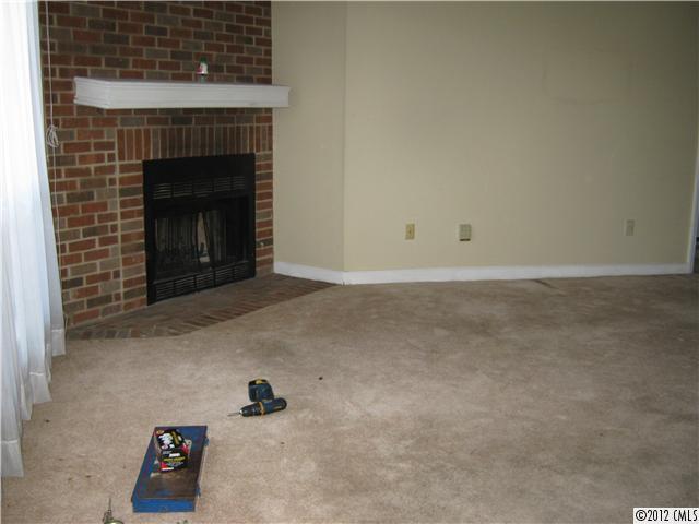 1604 Sharon Road West, Unit 29 Charlotte, NC 28210 - Photo 3 of 5 a view of empty room with fireplace