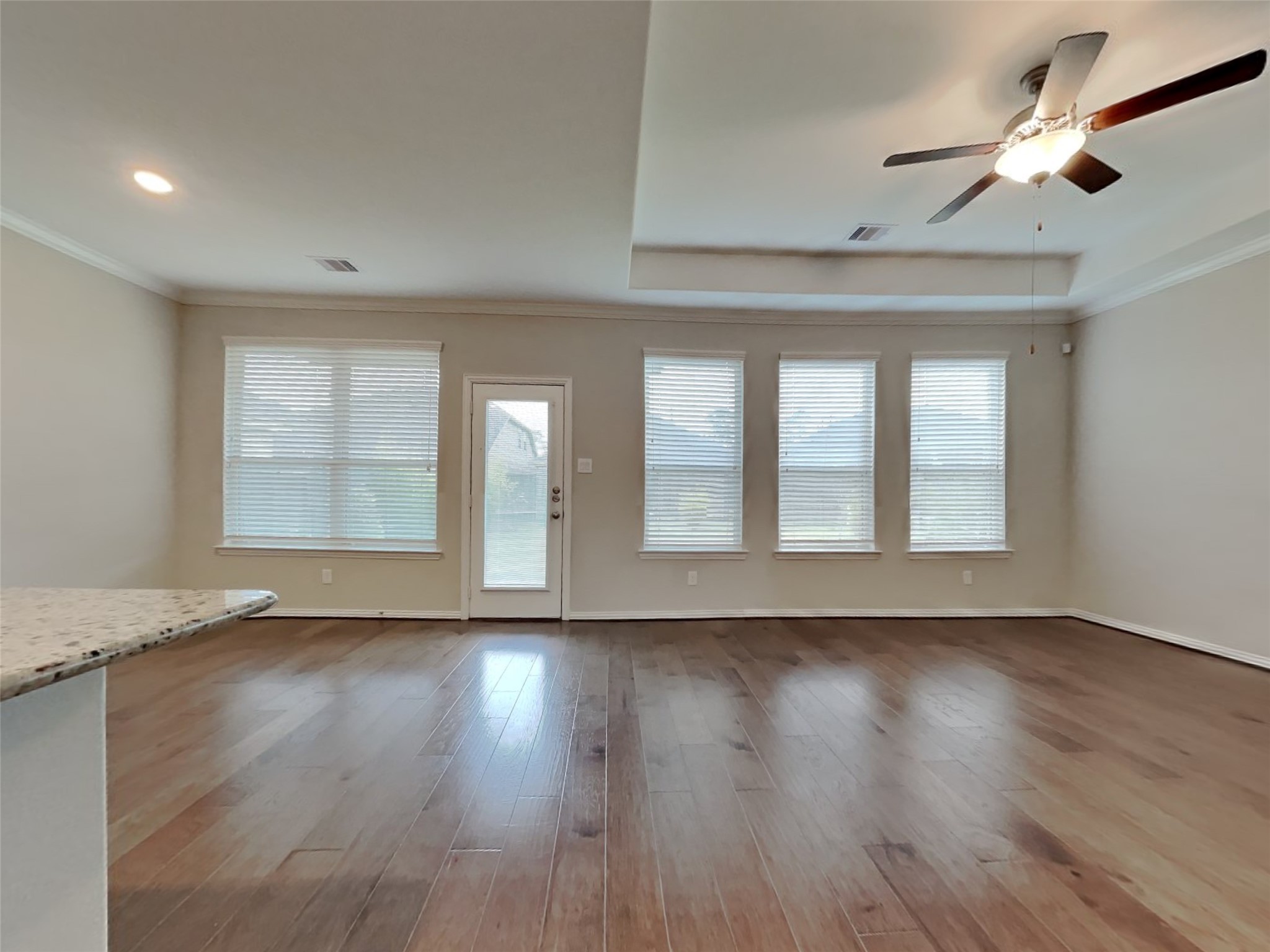 3434 Stablewood Grove Lane Spring, TX 77386 - Photo 3 of 22 a view of an empty room with wooden floor and a window