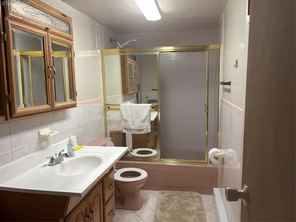 a bathroom with a sink a toilet and mirror
