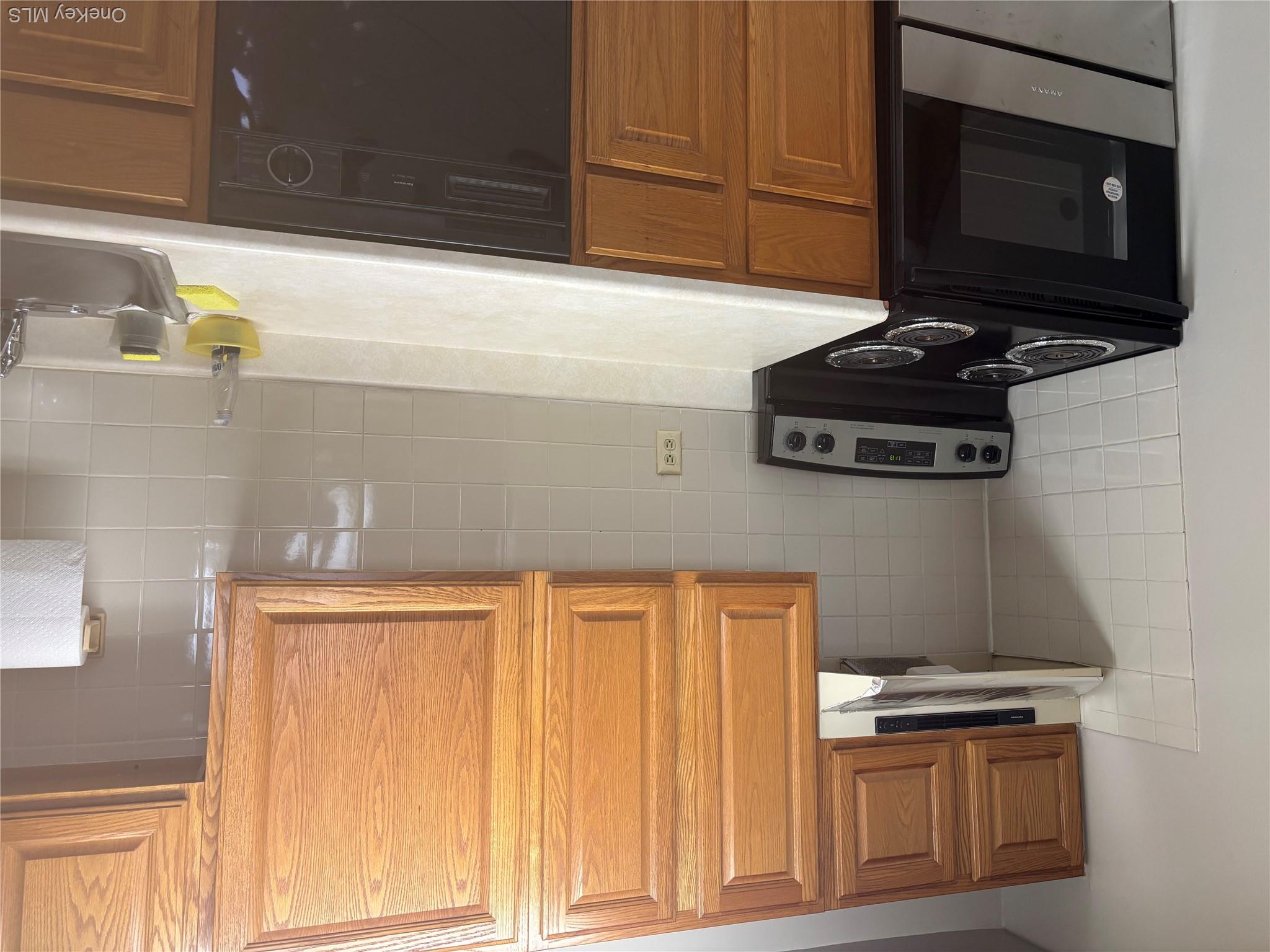 5 White Gate Road, Unit A Wappingers Falls, NY 12590 - Photo 7 of 15 a kitchen with stainless steel appliances a stove a microwave and cabinets