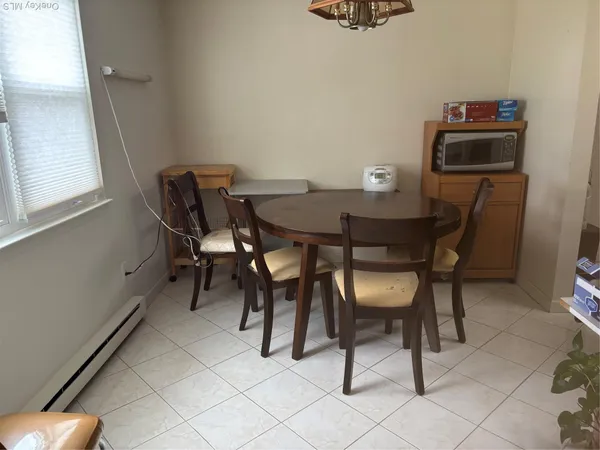 a view of a dining room with furniture and a window