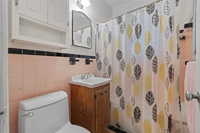 a kitchen with a stove top oven and refrigerator
