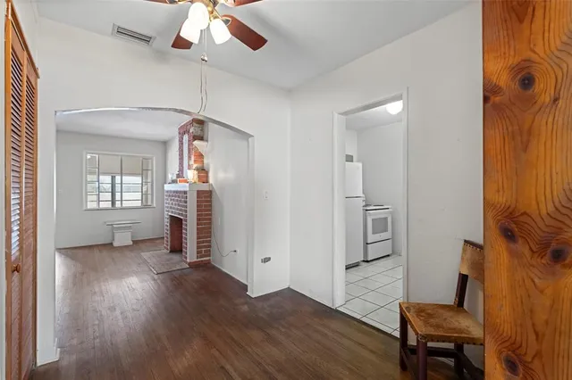 a view of a room with a ceiling fan and closet