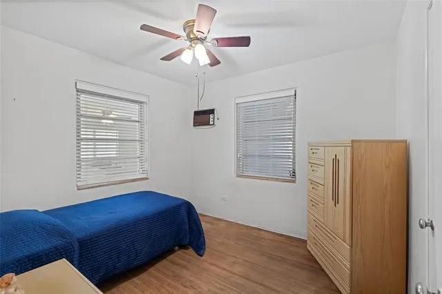a kitchen with white cabinets and a window