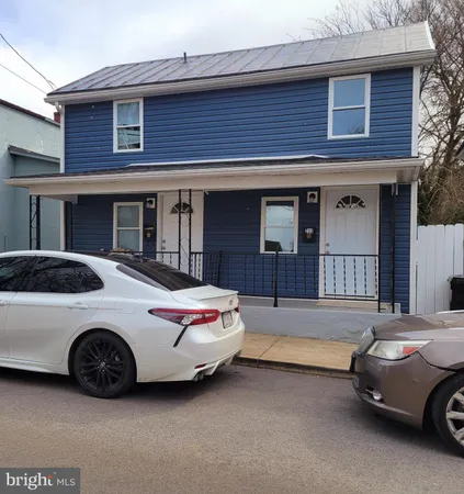 a car parked in front of a brick house