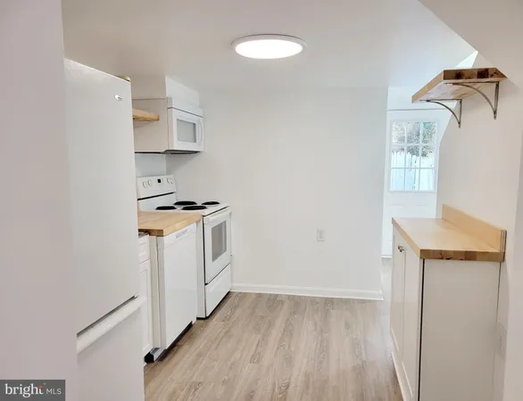 a utility room with cabinets washer and dryer