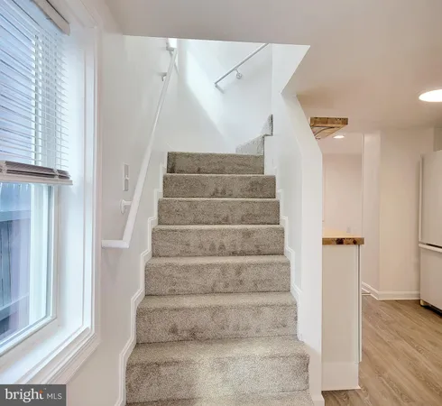 a view of staircase with white walls and windows
