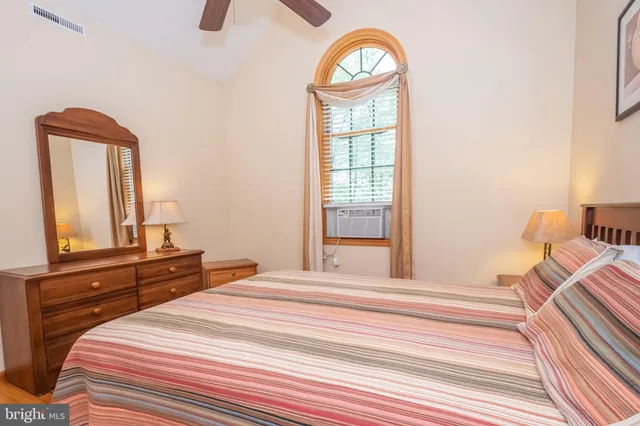 a bedroom with a bed and a dresser