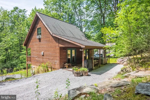 a view of a house with a yard and sitting area