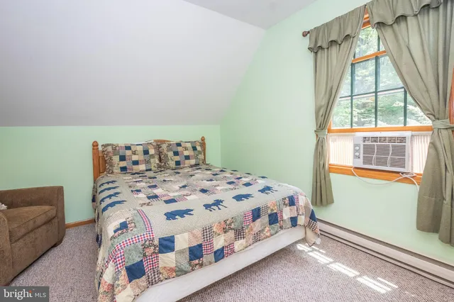 a bedroom with a bed next to a window