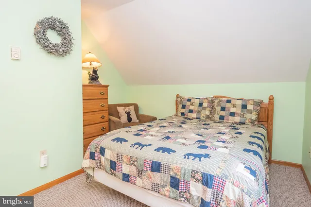 a bedroom with a bed and lamp