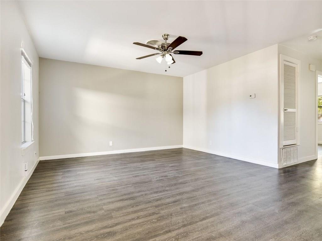6113 Manor Road, Unit A Austin, TX 78723 - Photo 3 of 13 Wood laminate flooring span this versatile living space illuminated by natural light.