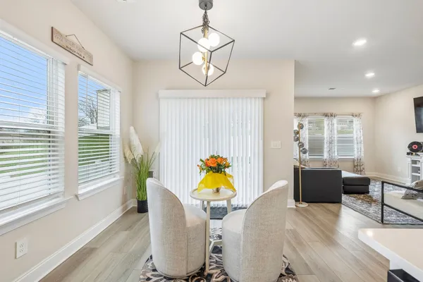 a view of a dining room with furniture wooden floor and windows