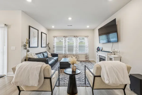 a bedroom with furniture and a flat screen tv