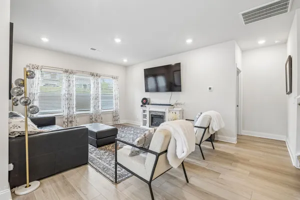 a view of a livingroom with furniture window and wooden floor