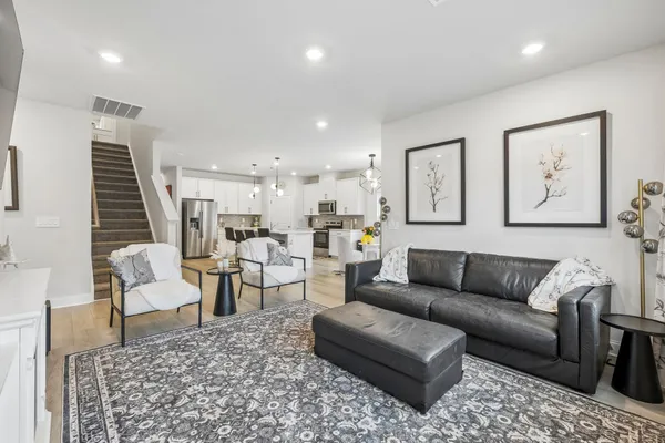 a living room with furniture and wooden floor