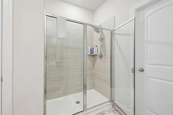 a bathroom with a glass shower door