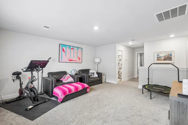a living room with furniture gym equipment and a view of living room