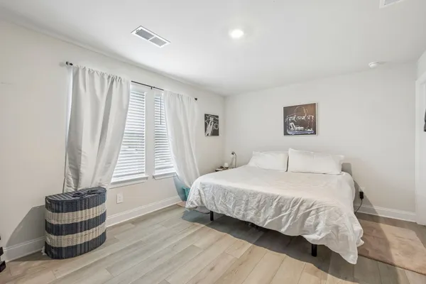 a bedroom with a bed and chair