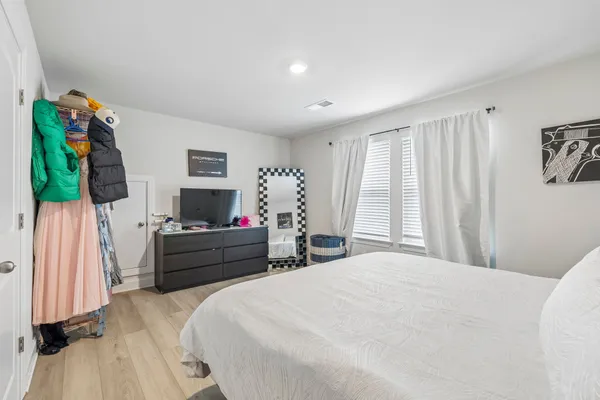 a bed room with a bed and a flat screen tv