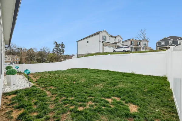 a view of green field with house in the background