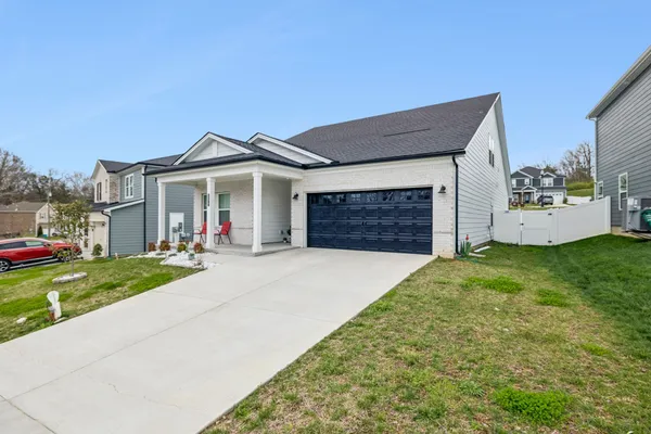 a front view of a house with a yard and garage