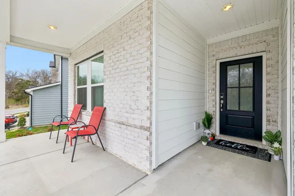 a view of an outdoor space with porch and furniture