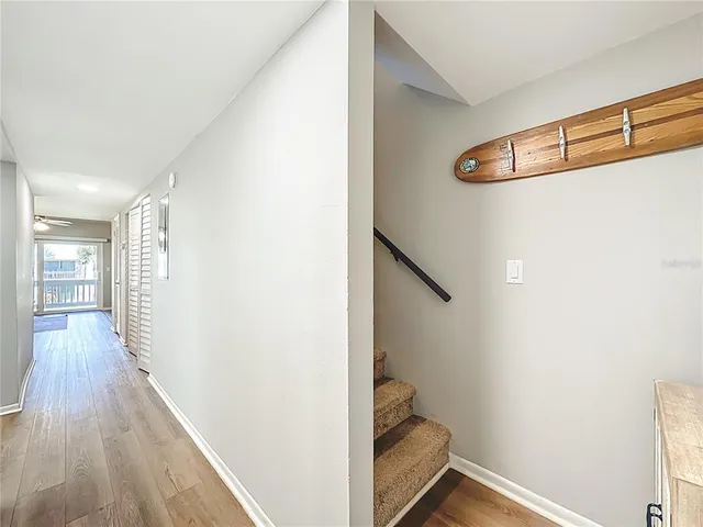 a view of hallway with wooden floor