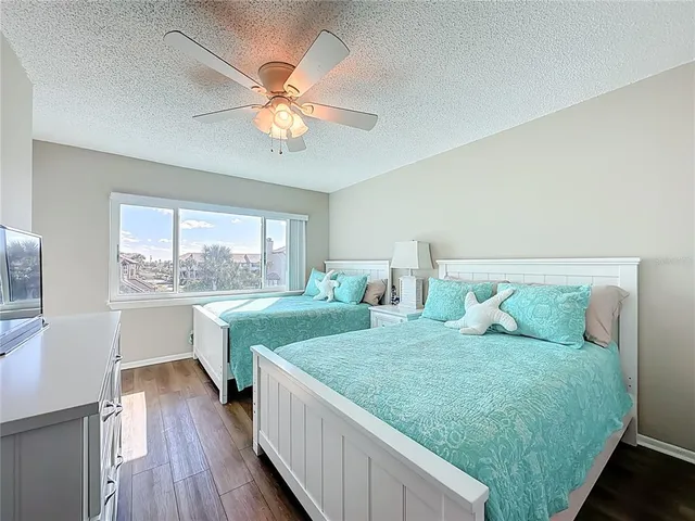 a spacious bedroom with two beds and a large window