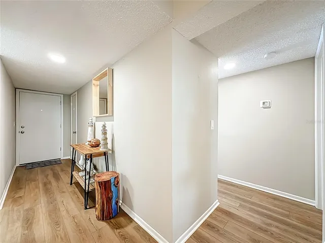 a view of a room with furniture and wooden floor