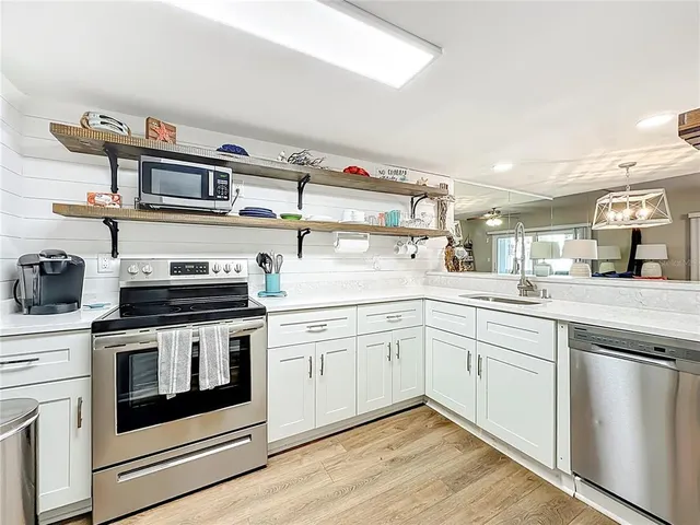 a kitchen with cabinets and stainless steel appliances