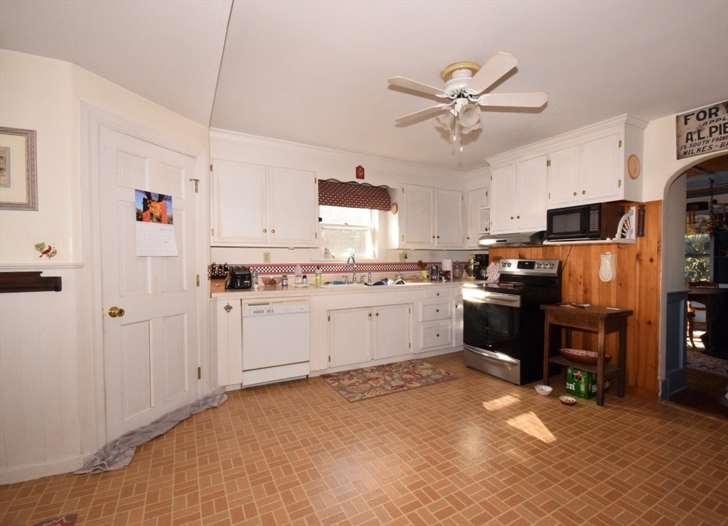 267 South Main Street Hopedale, MA 01747 - Photo 16 of 24 a kitchen with cabinets a window and stainless steel appliances