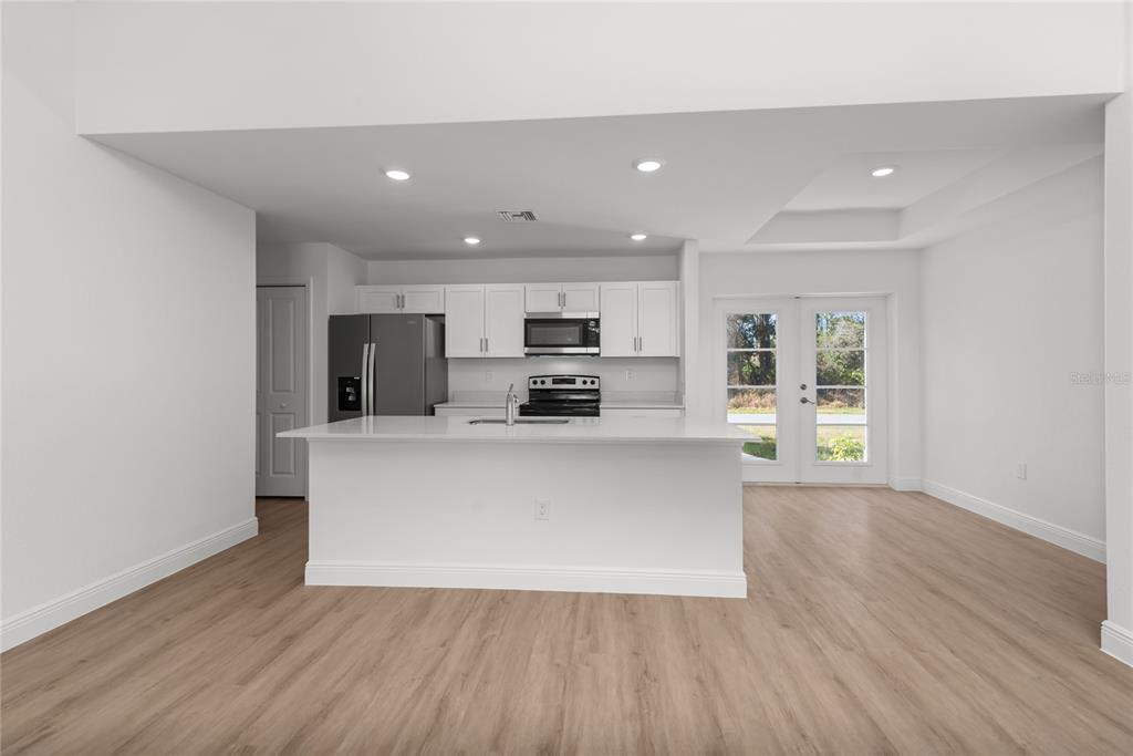107 Blue Road Rotonda West, FL 33947 - Photo 3 of 11 a view of kitchen with stainless steel appliances granite countertop a stove top oven a sink and a microwave